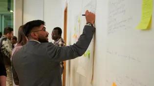 Researcher writing down ideas at a workshop