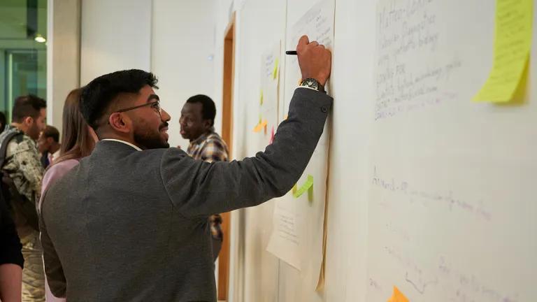 Researcher writing down ideas at a workshop