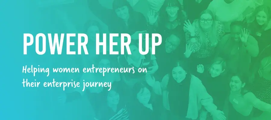A group of women waving at the camera with the text 'Power Her Up'
