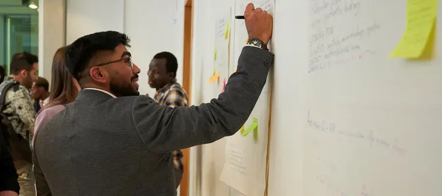 Researcher writing down ideas at a workshop