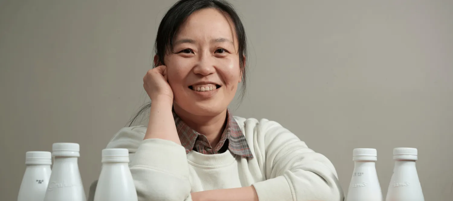 Women wearing jumper with plastic bottles for recycling 