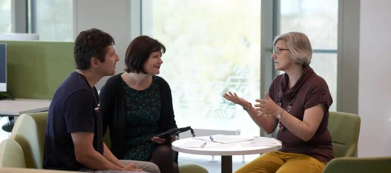 Three people meeting to discuss ideas