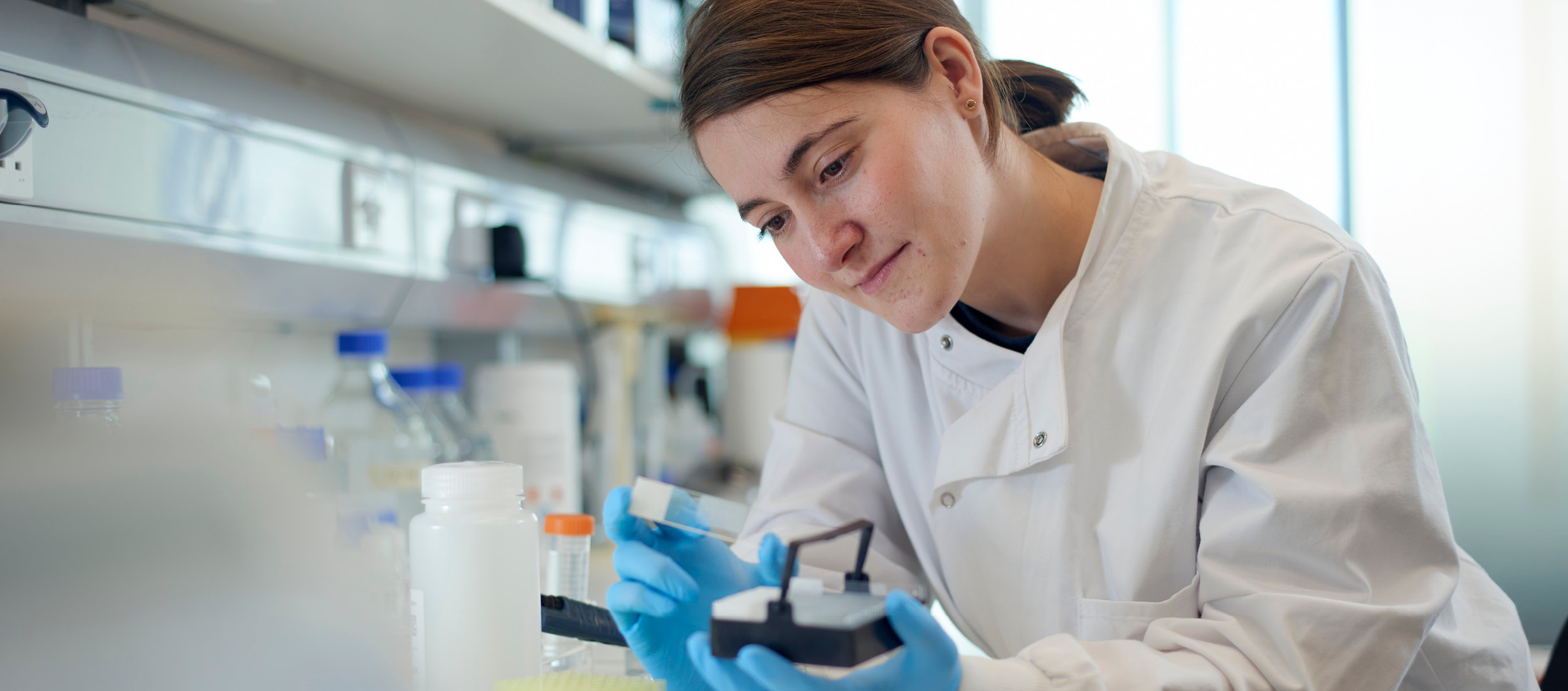 This image shows Sofia Ferreira Gonzalez inspecting a slide.