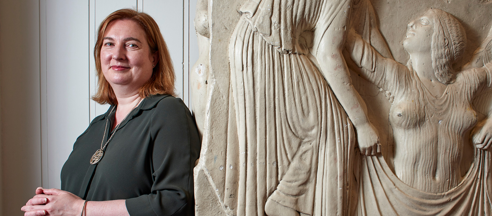 Image of Melissa Terras beside a marble freize