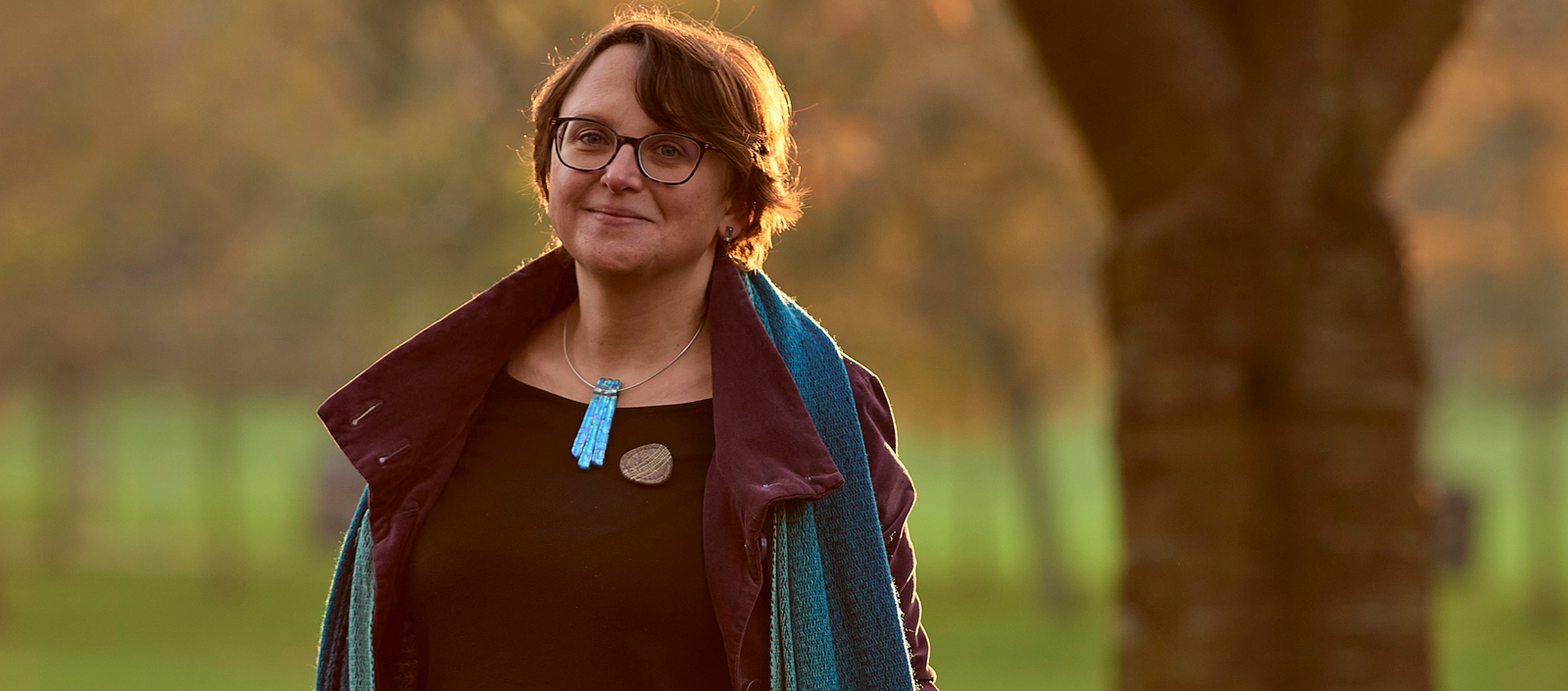 Image of Dr Tanja Romankiewicz standing next to a tree